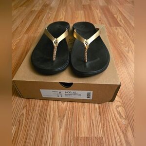 OluKai Women's Sandals with Gold Straps and Black Soles Size 11